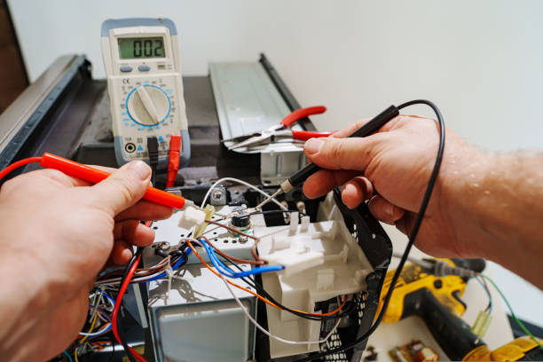 Technician reviewing microwave repair diagnostics