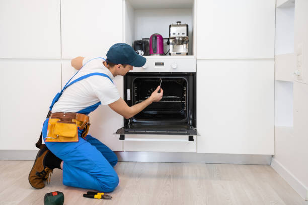 Technician reviewing oven repair diagnostics
