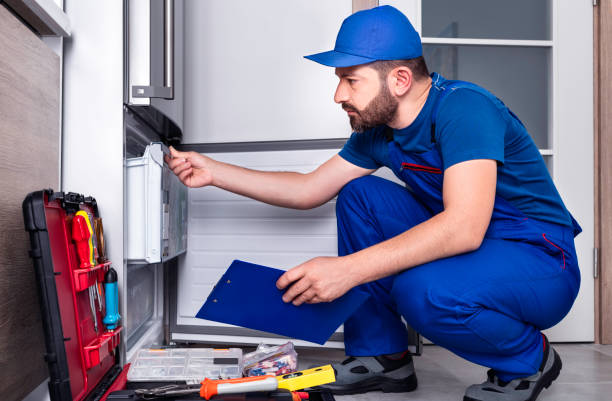 Technician performing a refrigerator diagnostic