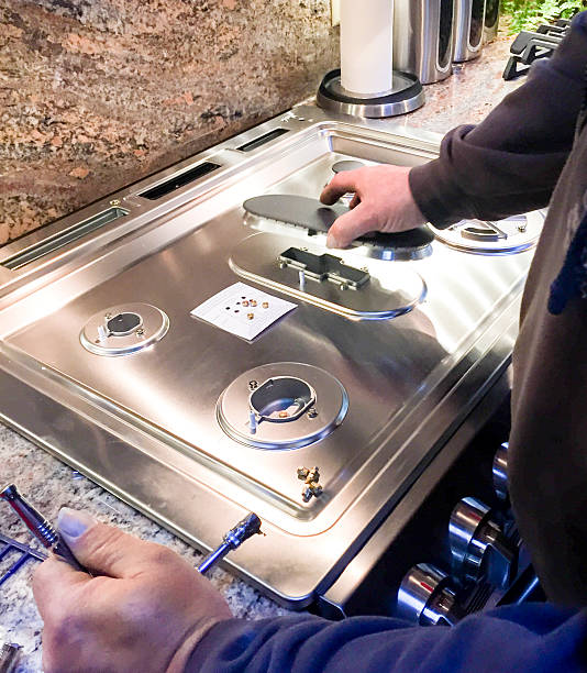 Technician reviewing stove repair diagnostics