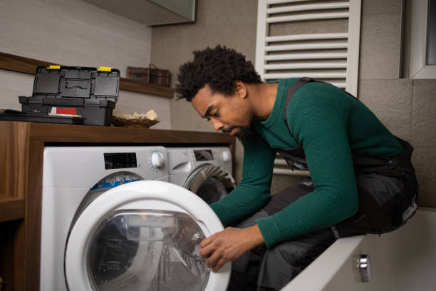 Washing machine repair technician working