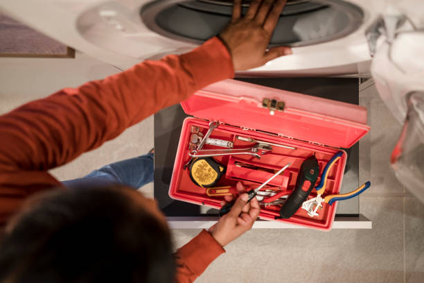 Technician performing a washing machine diagnostic